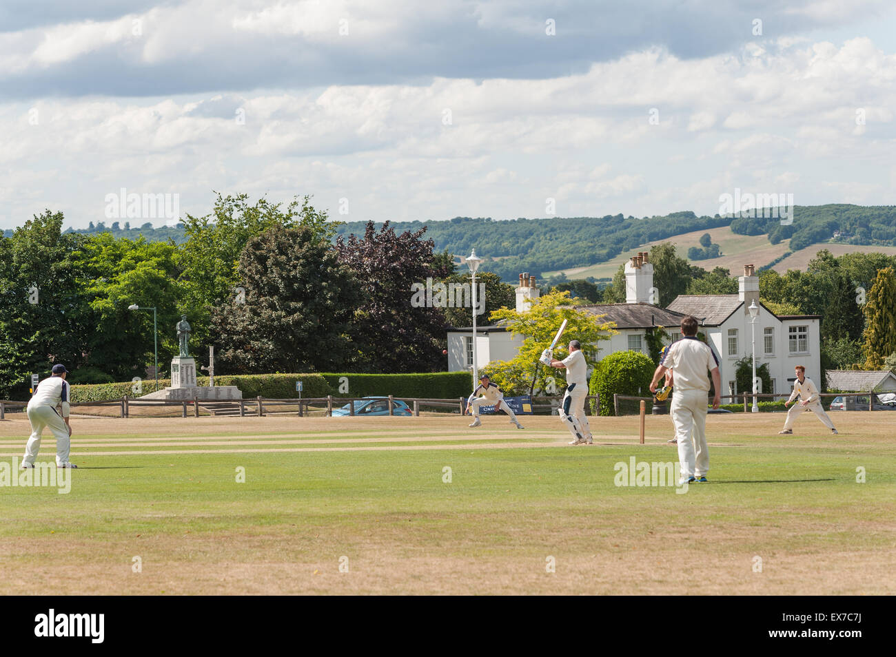 Typically British a game of cricket played on The Vine Sevenoaks surrounded by the 7 oaks with north downs and club house Stock Photo