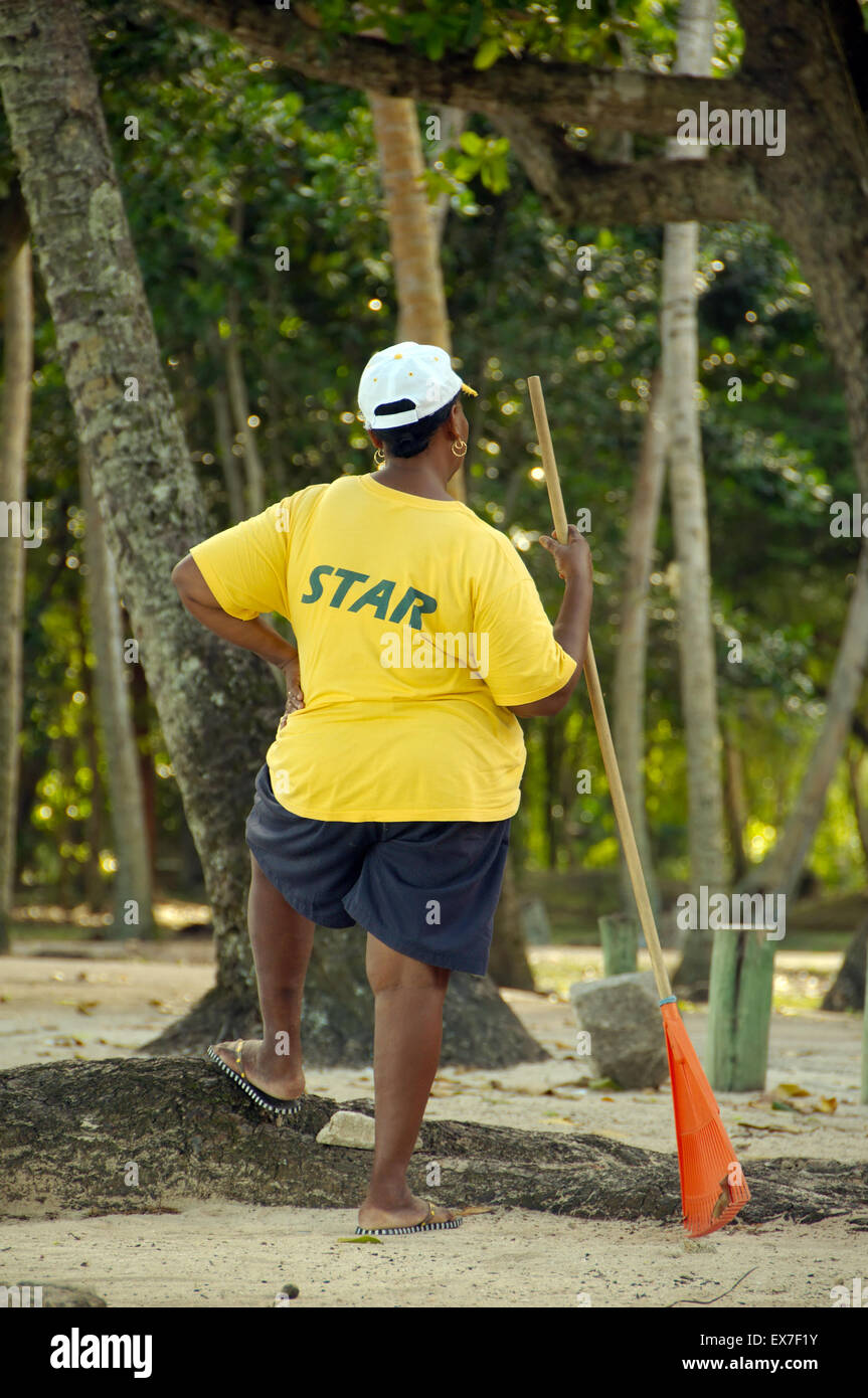 Major woman worker in a shirt with the inscription "star",  Mahe island, Seychelles Stock Photo