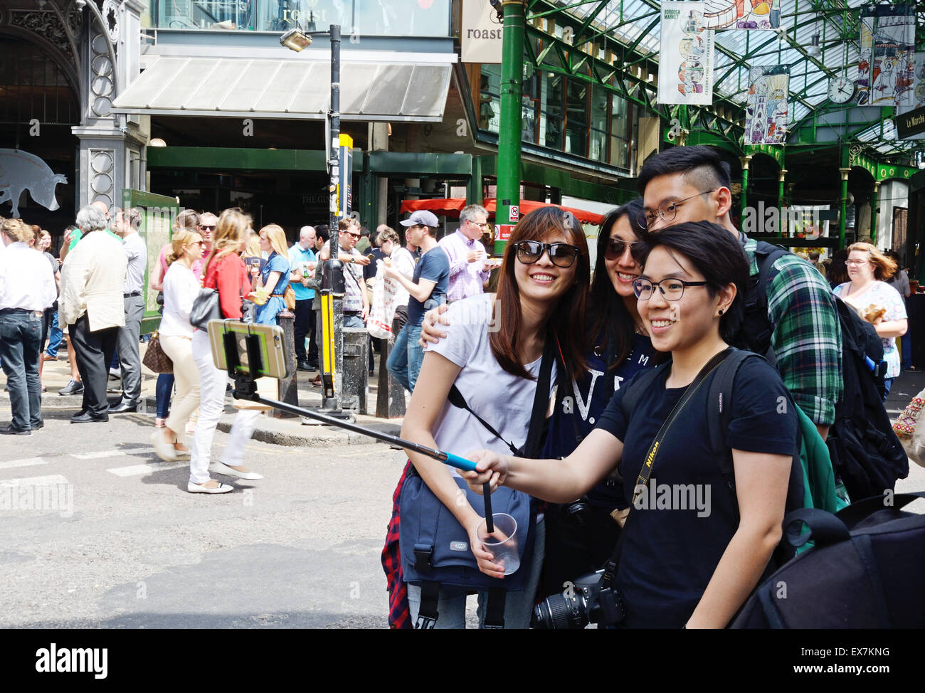 Girls taking selfies, Borough Market, London. England. Stock Photo