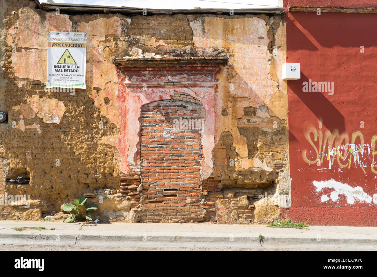 Interesting textures of a crumbling brick and plaster wall in Oaxaca Mexico Stock Photo