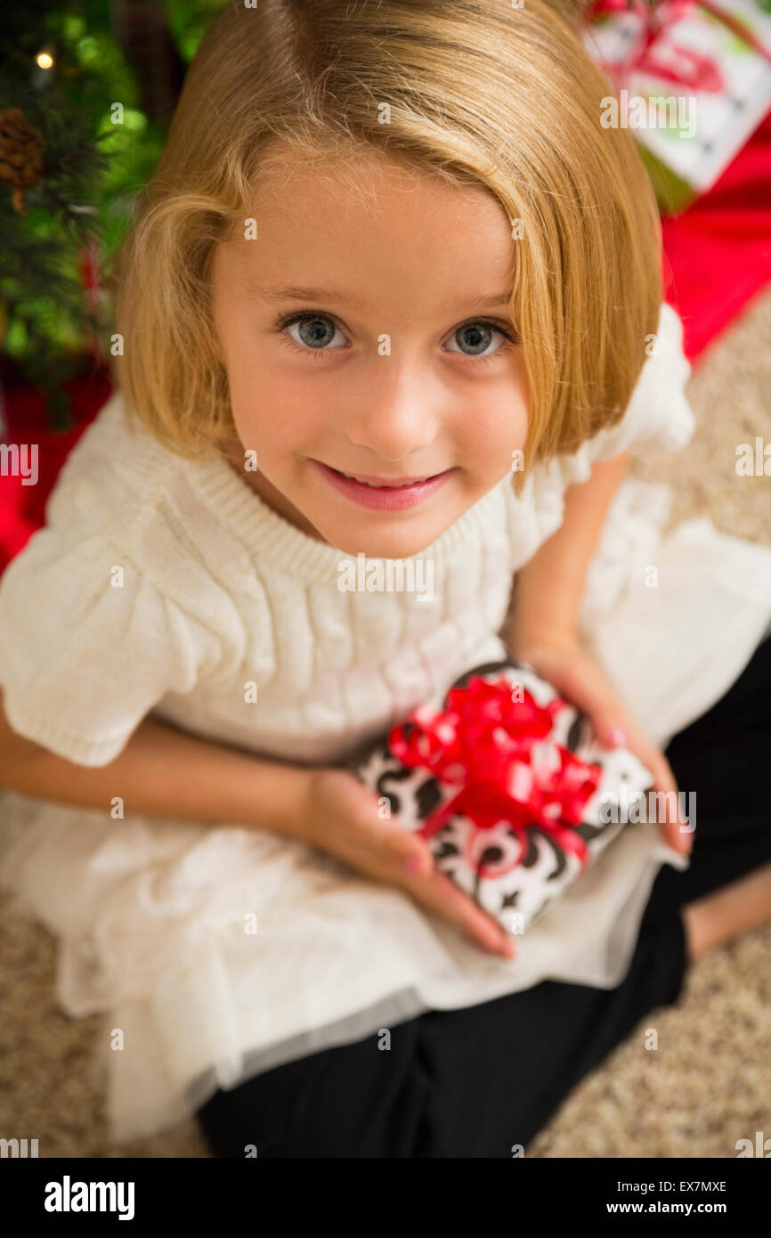 Portrait of girl (6-7) holding Christmas present Stock Photo - Alamy