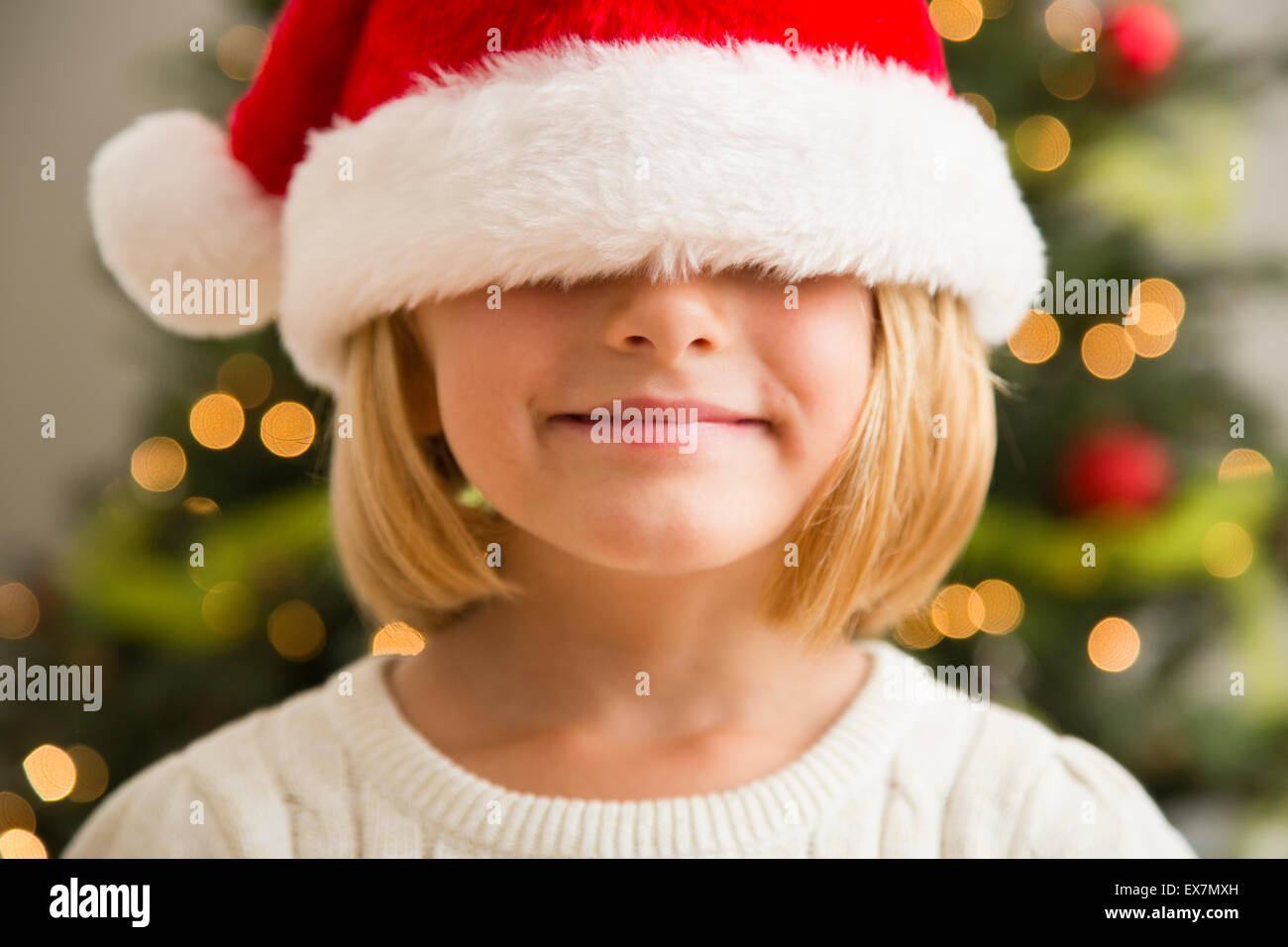 Girl (6-7) wearing Santa hat Stock Photo