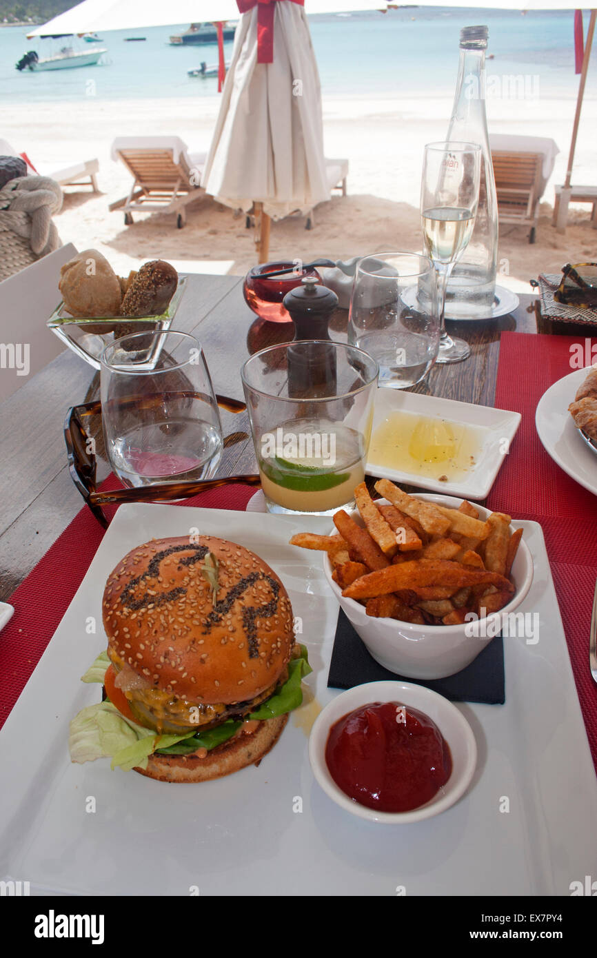A hamburger served at the Sand Bar restaurant at the Eden Rock Hotel, with the hotel's initials written on the bun Stock Photo