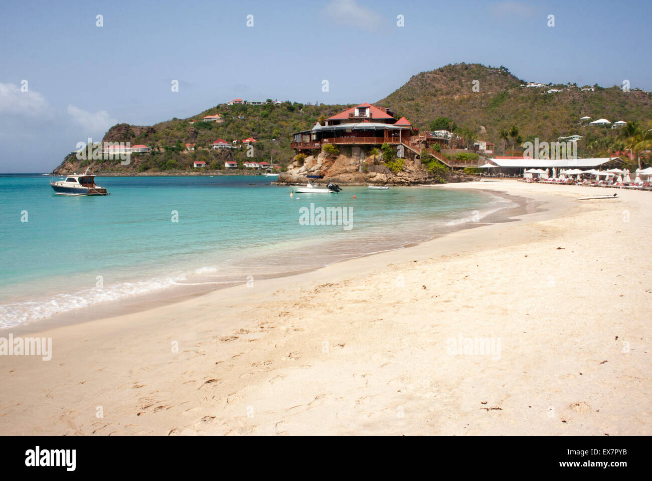 The white sand of St. Jean Beach, in St. Barts, with the Eden Rock in the background Stock Photo