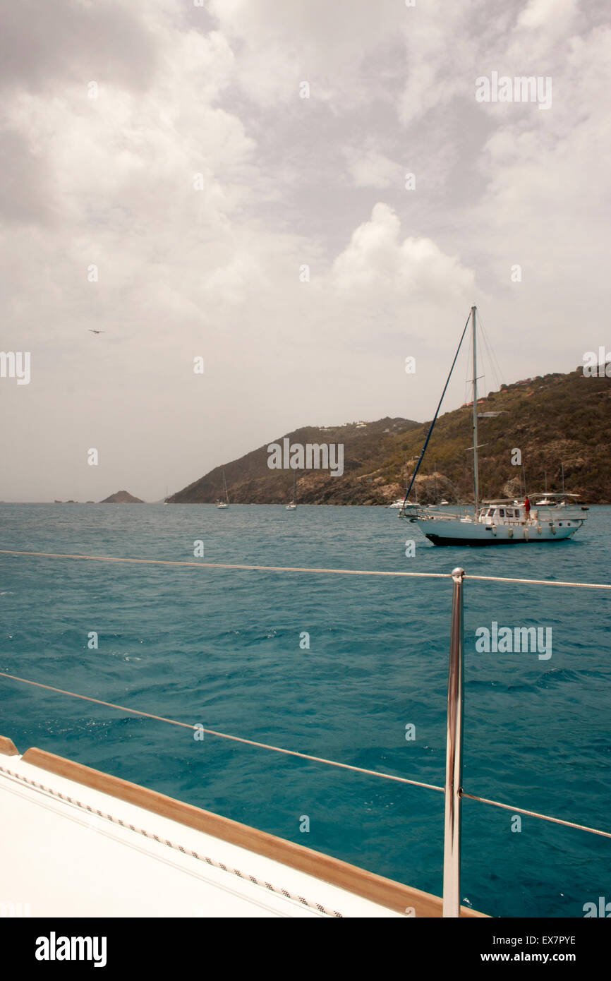 Clouds move in over the turquoise Caribbean Sea and the island of St. Barts, as viewed from a boat Stock Photo