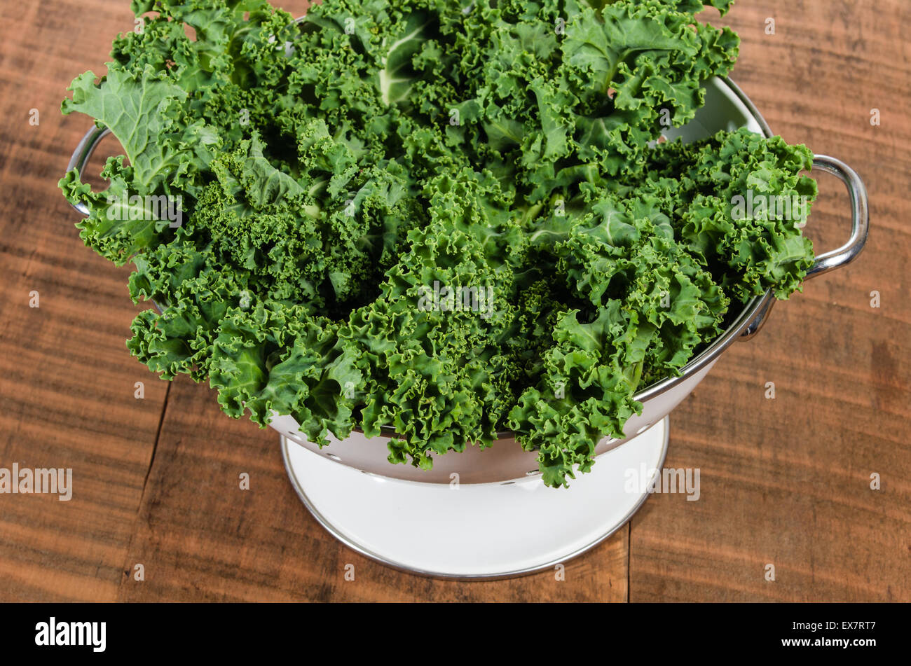 Colandar of green curly kale leaves Stock Photo