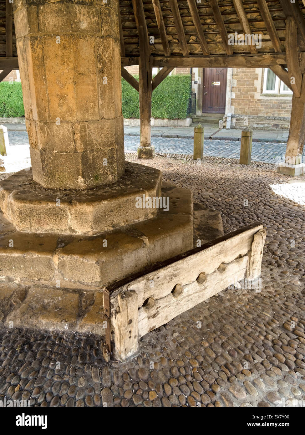 Medieval wooden stocks at the Old Butter Cross, Oakham, Rutland, England, UK. Stock Photo