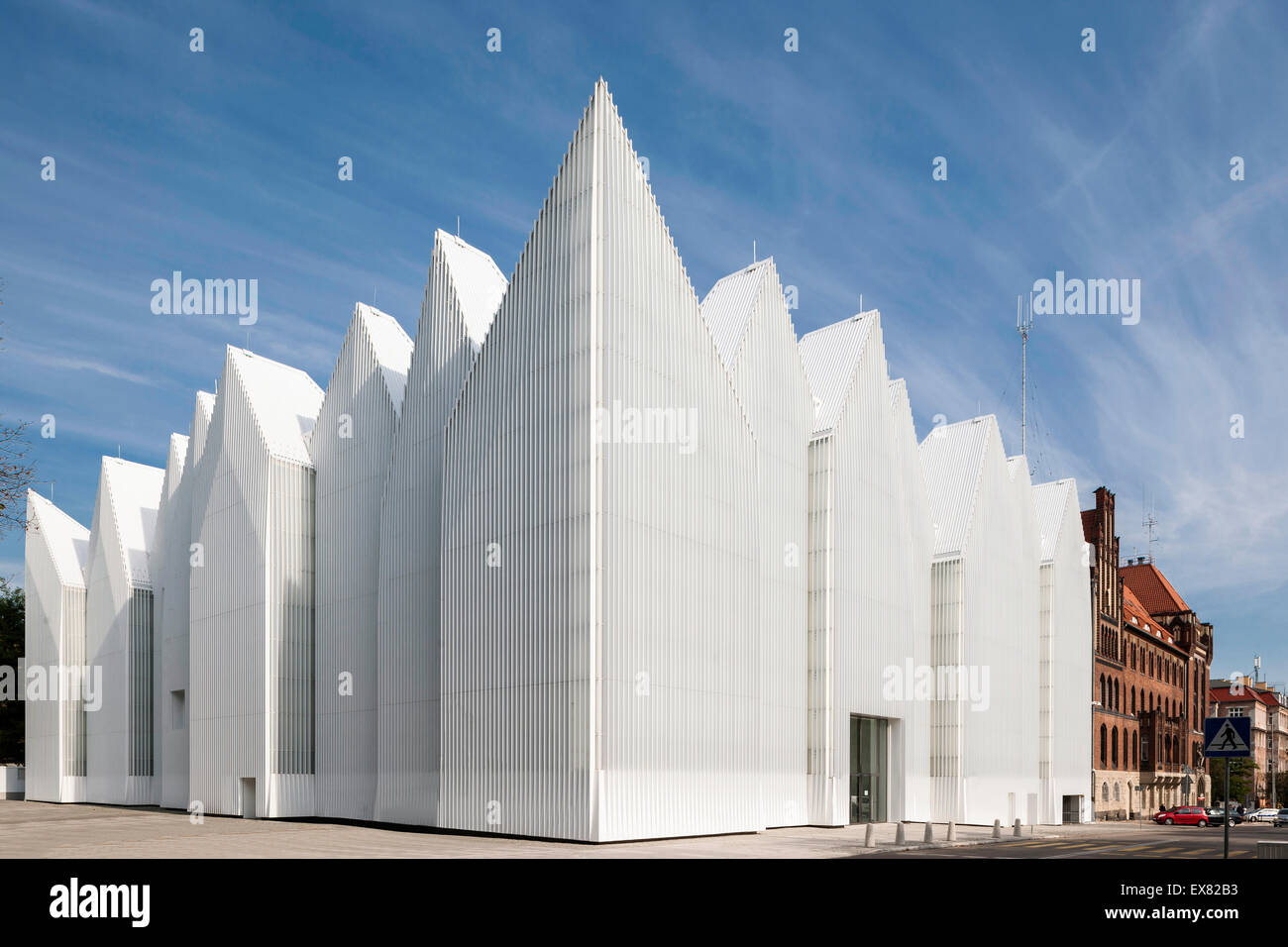 Corner elevation with zigzag roof profile against clear sky. Szczecin Philharmonic Hall, Szczecin, Poland. Architect: Estudio Ba Stock Photo