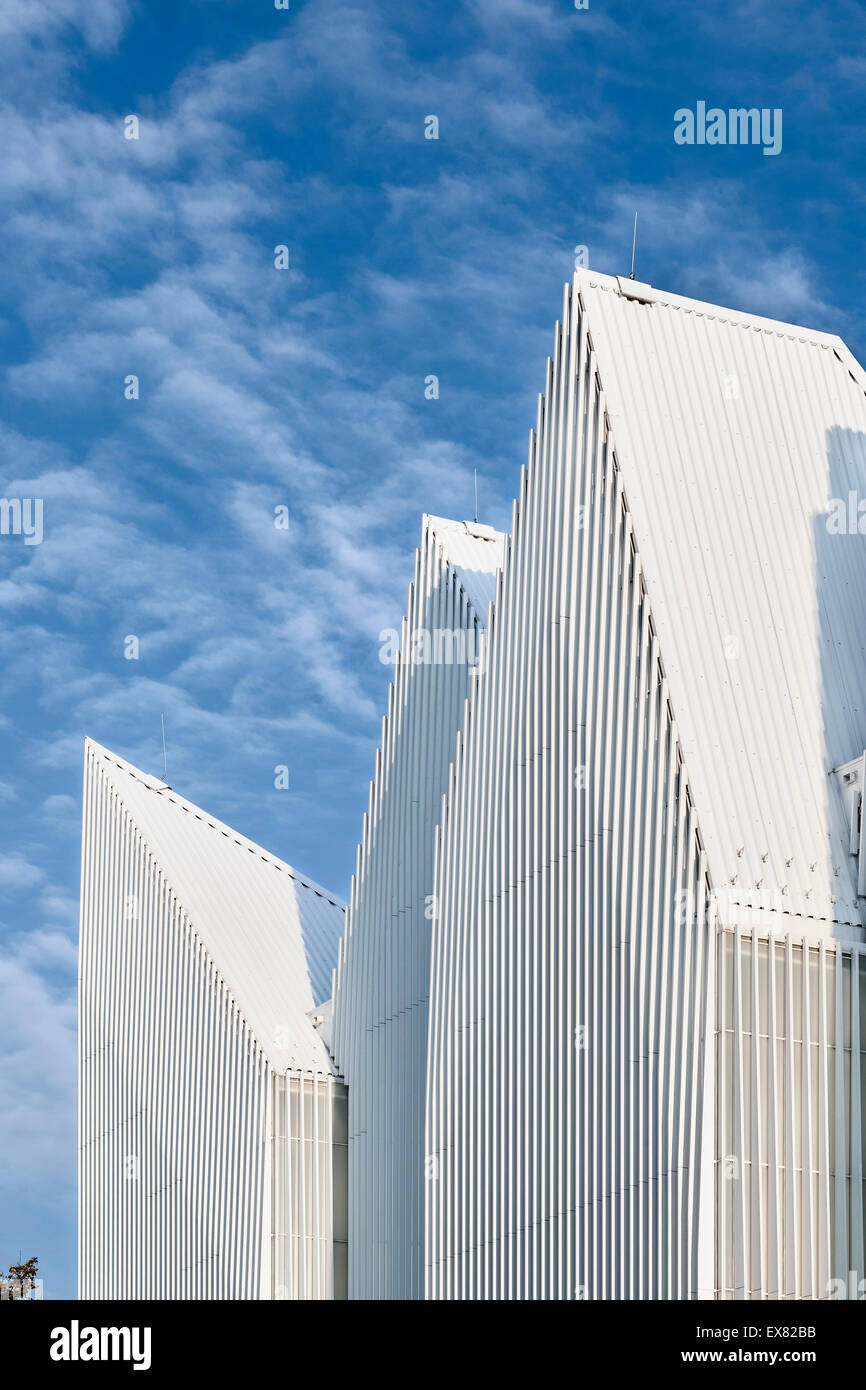 Facade with zigzag roof profile against cloudy sky. Szczecin Philharmonic Hall, Szczecin, Poland. Architect: Estudio Barozzi Vei Stock Photo
