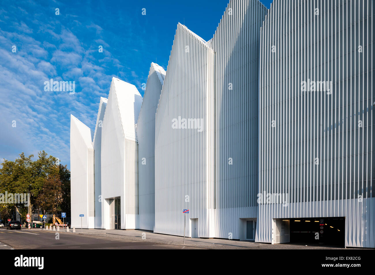 Facade perspective with walkway and parking garage entrance. Szczecin Philharmonic Hall, Szczecin, Poland. Architect: Estudio Ba Stock Photo