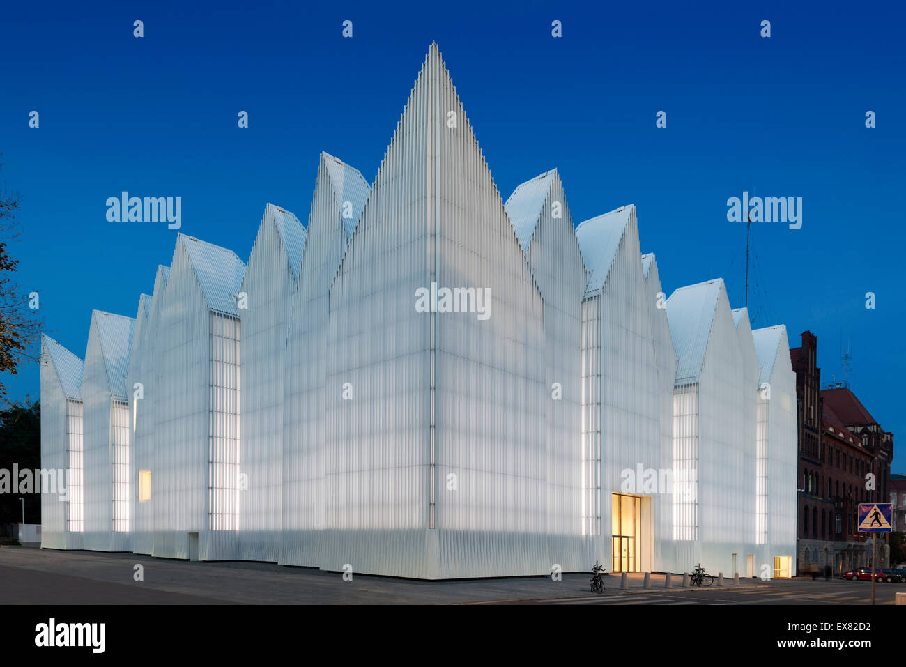 Corner elevation with zigzag roof profile against night sky. Szczecin Philharmonic Hall, Szczecin, Poland. Architect: Estudio Ba Stock Photo