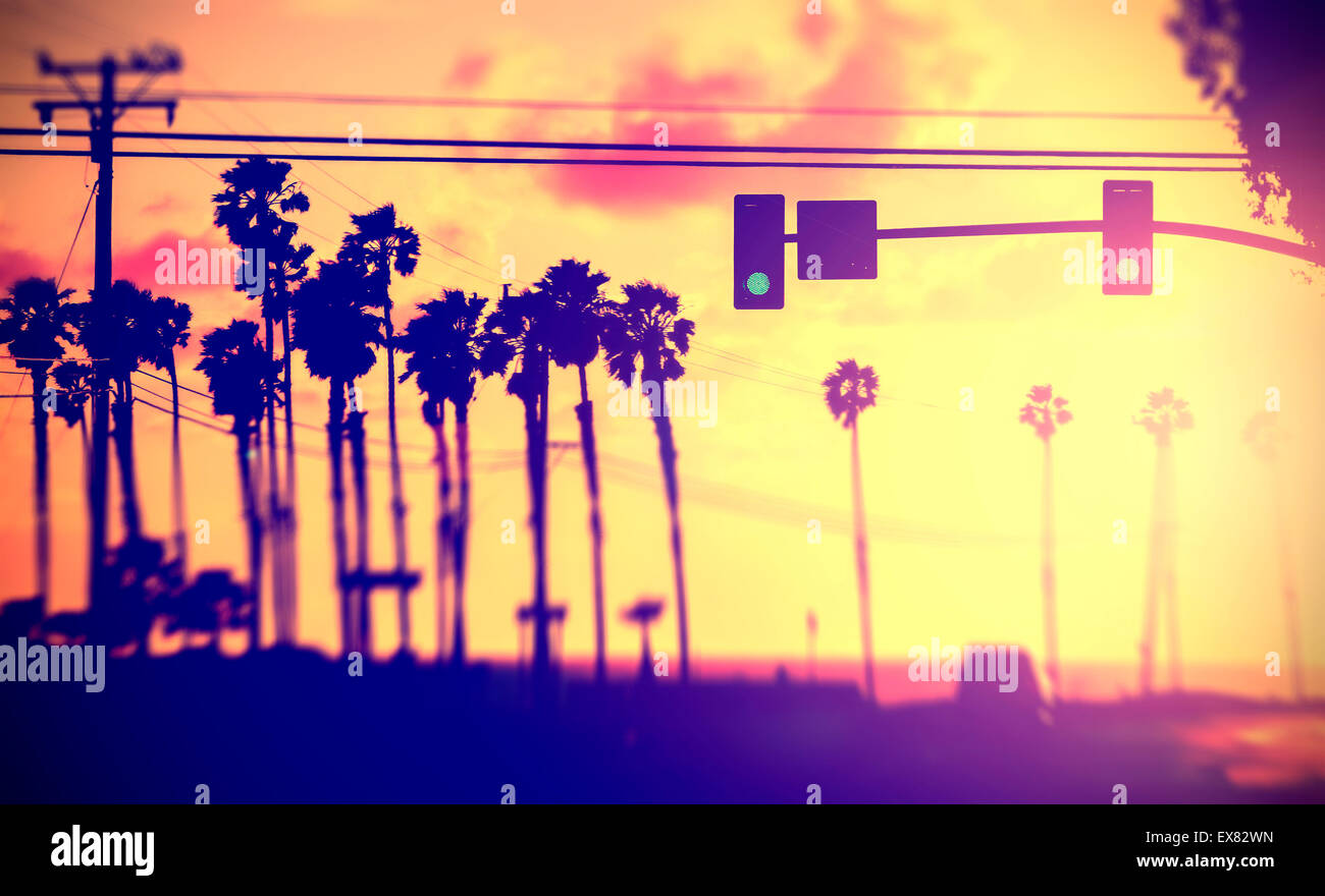 Vintage filtered blurred picture of street against sun, California, USA. Stock Photo