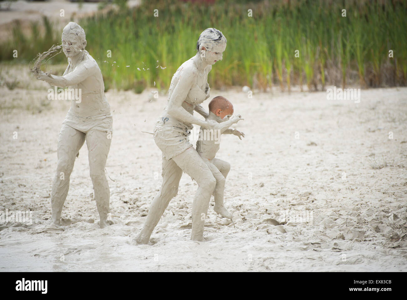 People enjoy hot weather and bathe in the mud pool with kaolin in ...