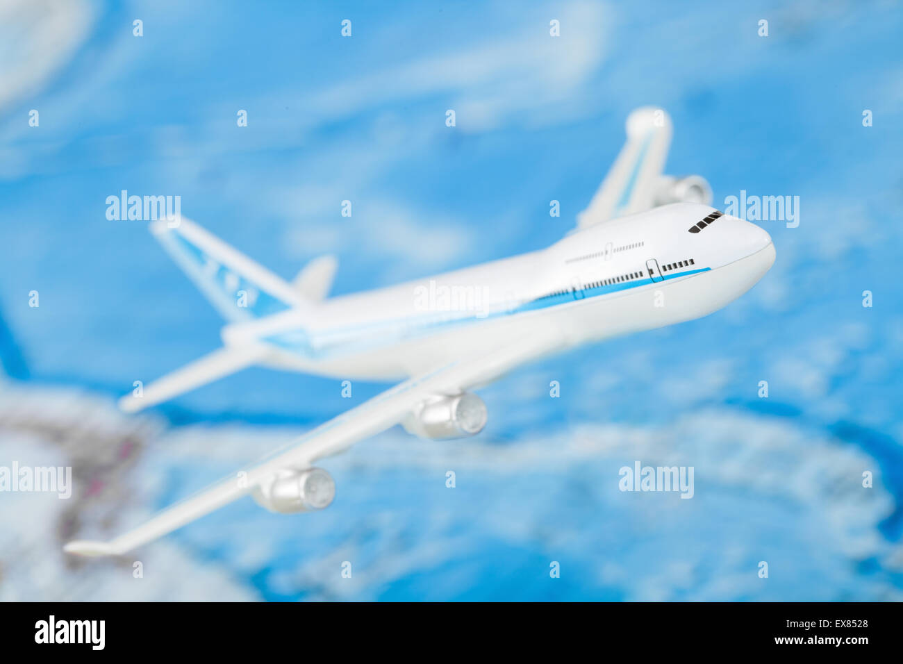 Small airplane with world map on background Stock Photo - Alamy