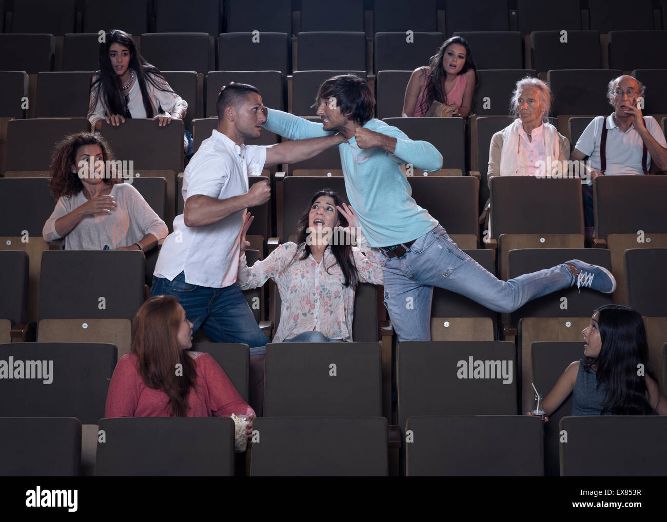 Two men fighting at a movie theater. Stock Photo