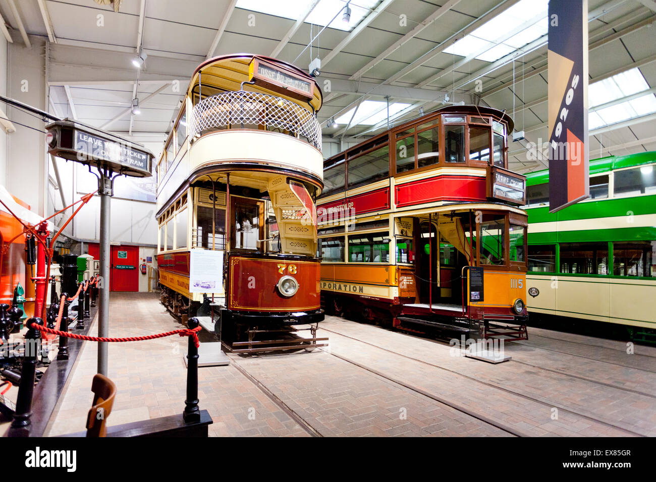 A selection of colourful trams inside the Exhibition Hall at the National Tramway Museum, Crich, Derbyshire, UK Stock Photo