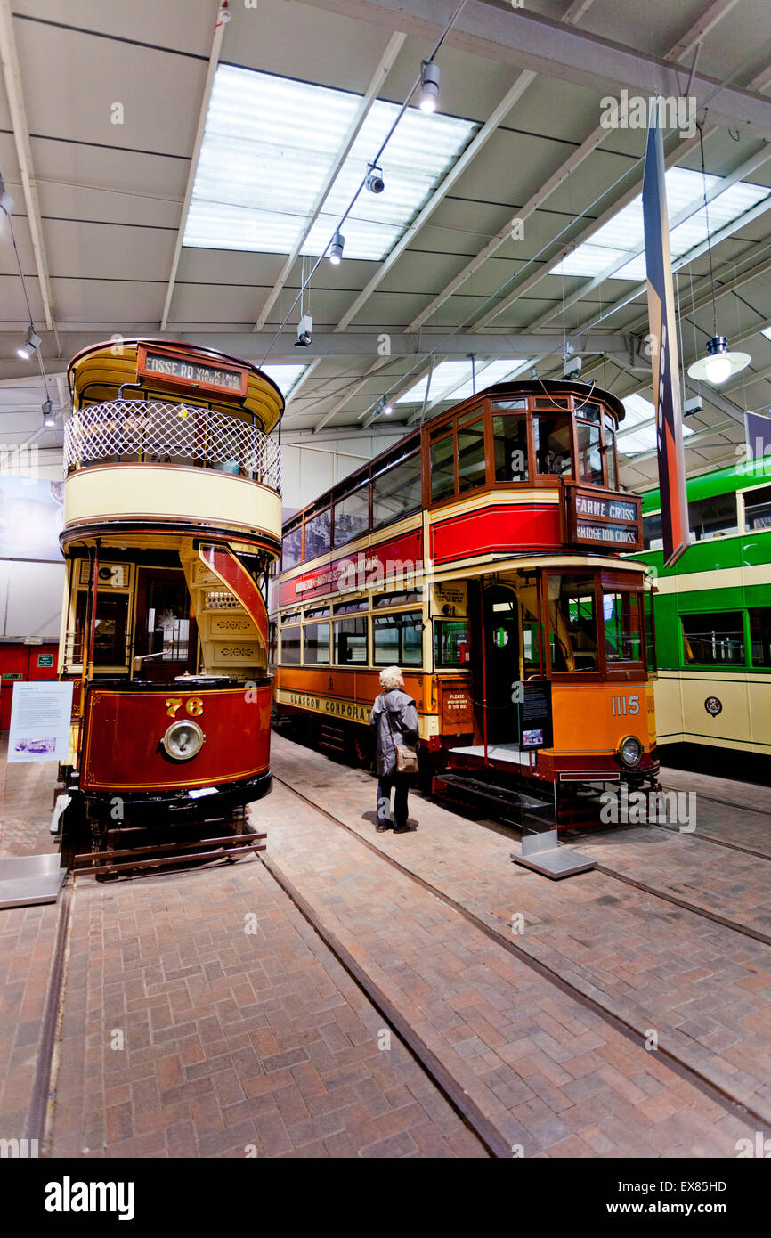 A visitor admiring a former 1929 Glasgow tram in the Exhibition Hall at the National Tramway Museum, Crich, Derbyshire, UK Stock Photo