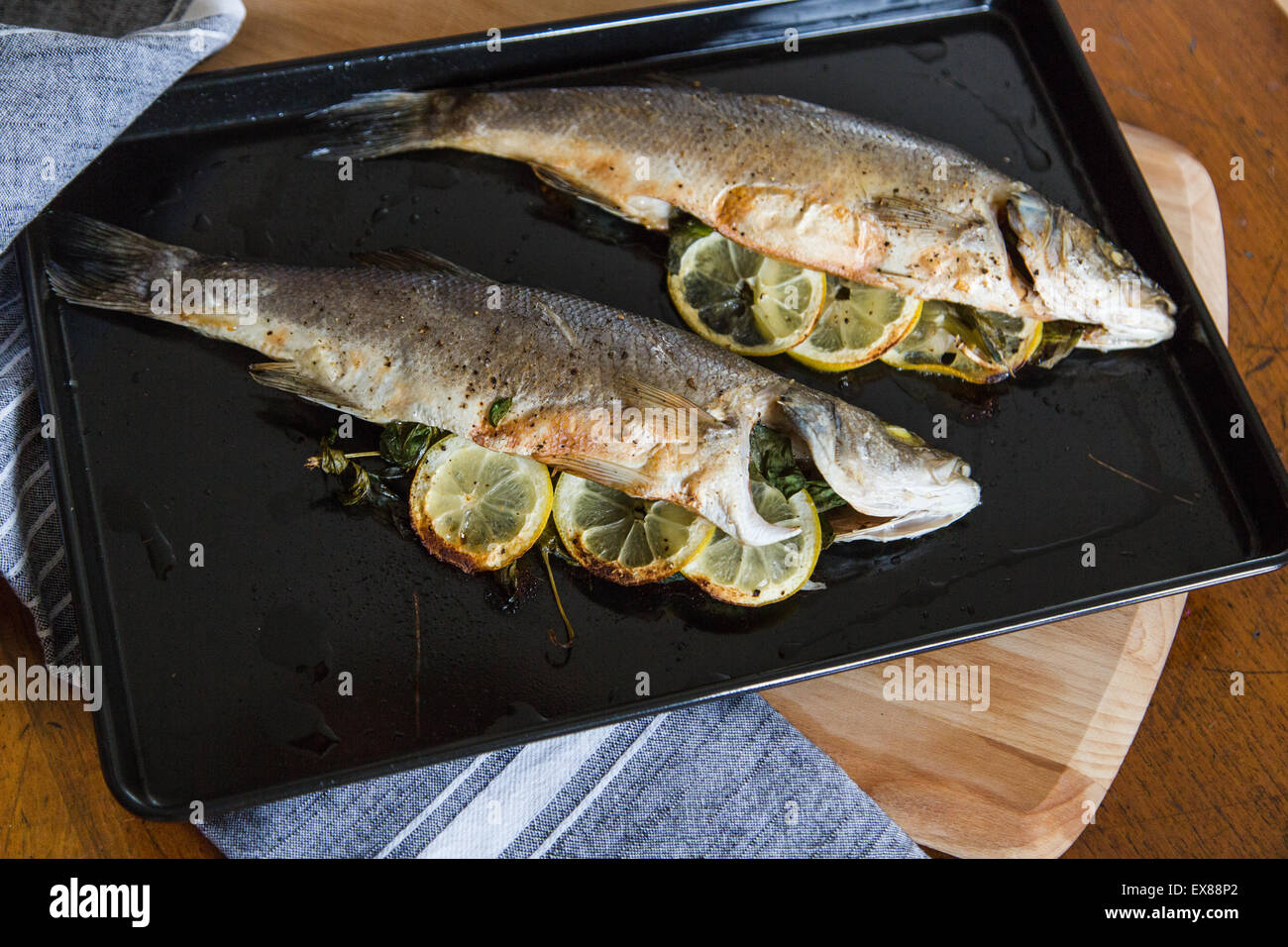 Oven Baked Sea Bass stuffed with basil and lemon, dinner, lunch, fish, roasted, healthy, Stock Photo