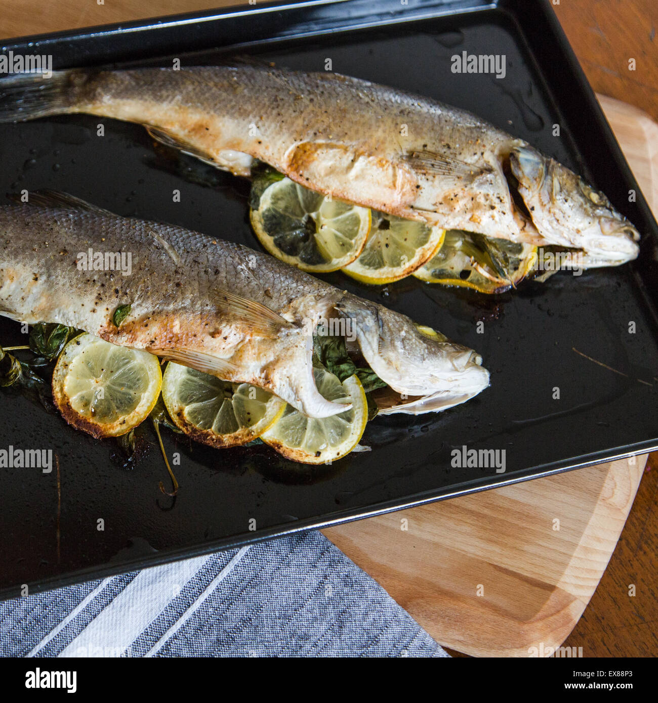 Oven Baked Sea Bass stuffed with basil and lemon Stock Photo