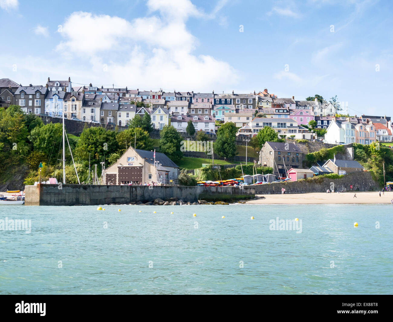 Colourful houses of New Quay, Ceredigion, Wales, seen from the sea on a sunny summer's day Stock Photo