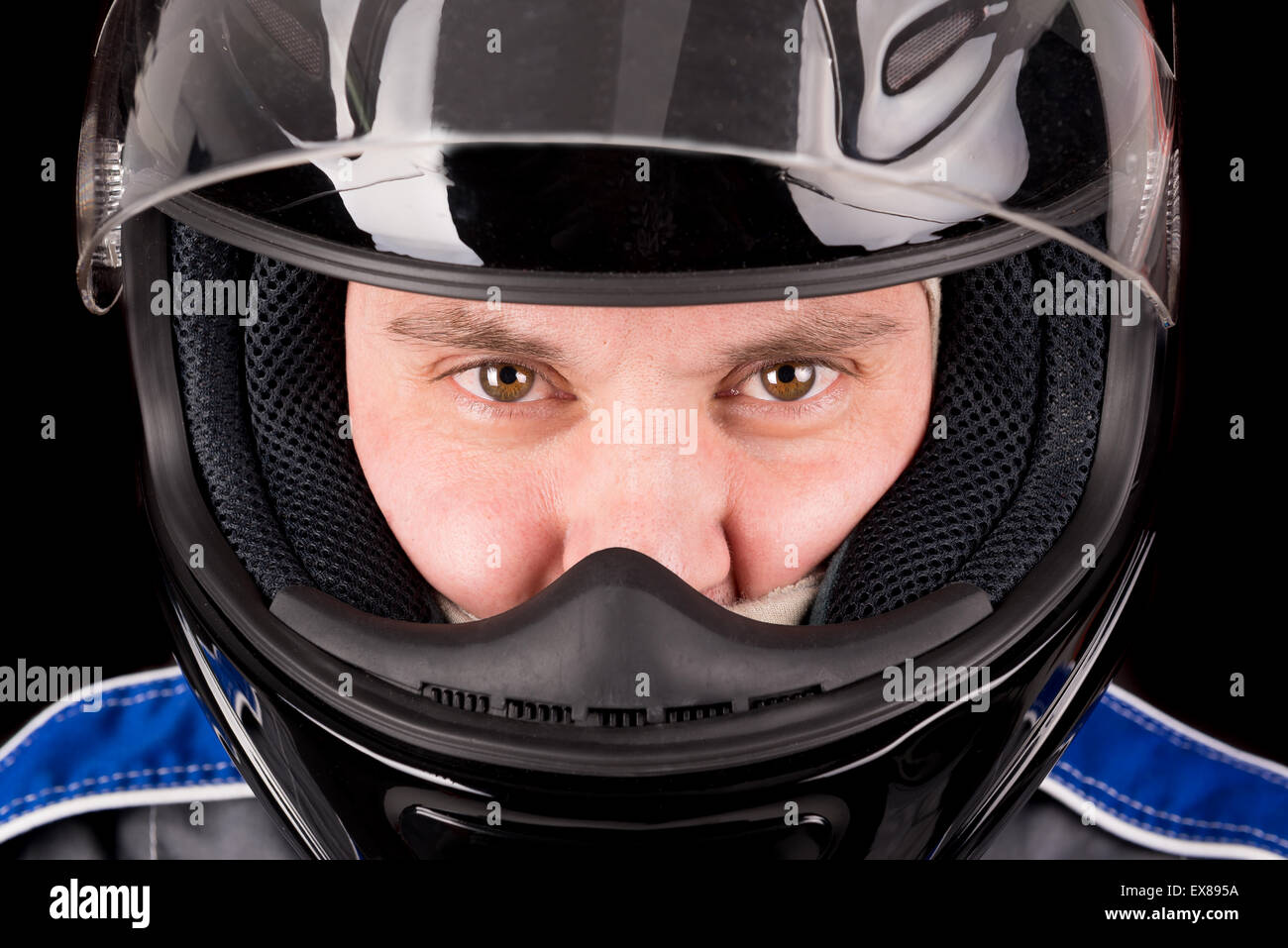 Real Racer With Helmet Racing driver posing with helmet isolated in black Stock Photo - Alamy