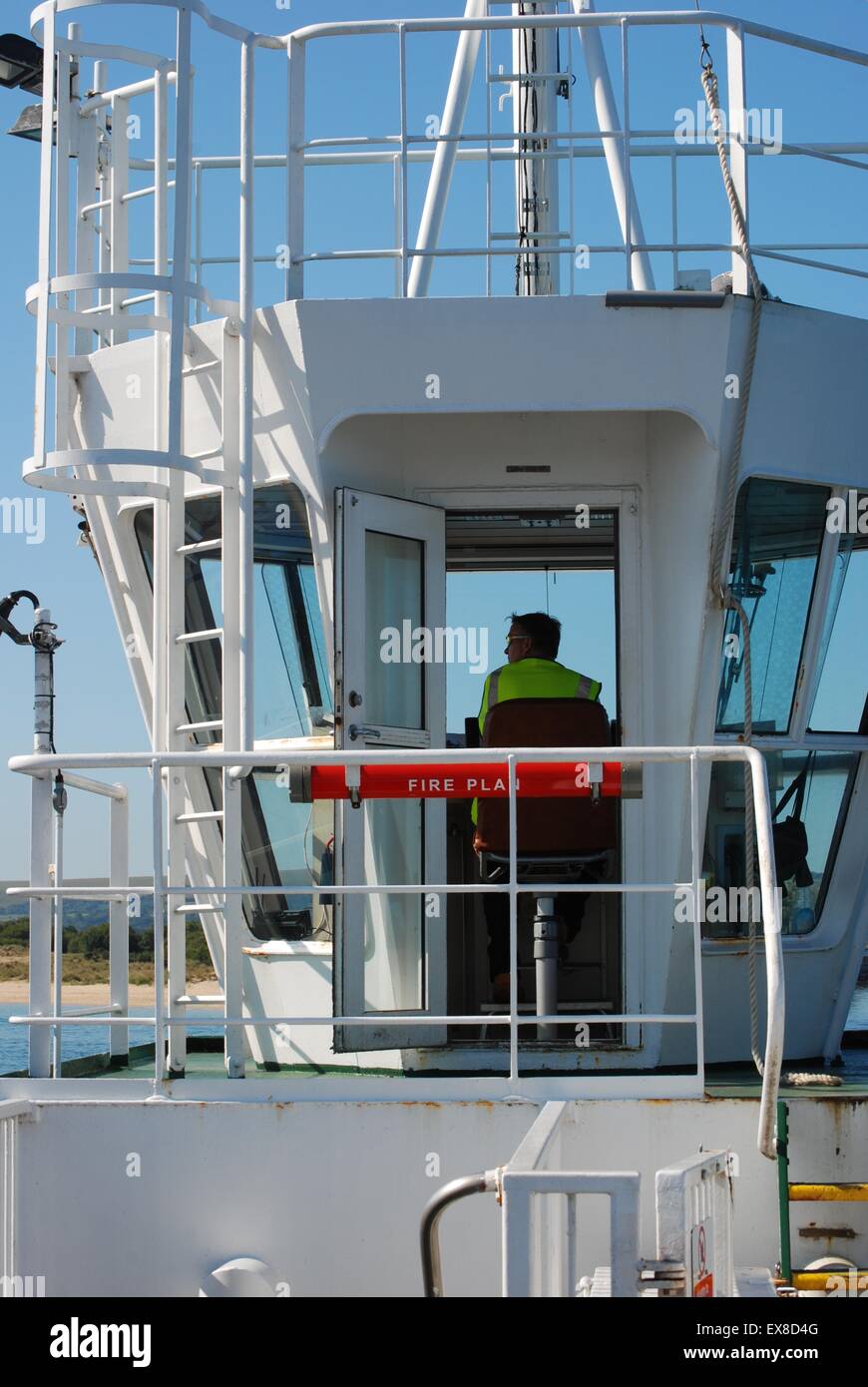 Sandbanks chain link ferry, Poole Harbour, Dorset, UK, pilot in the cab