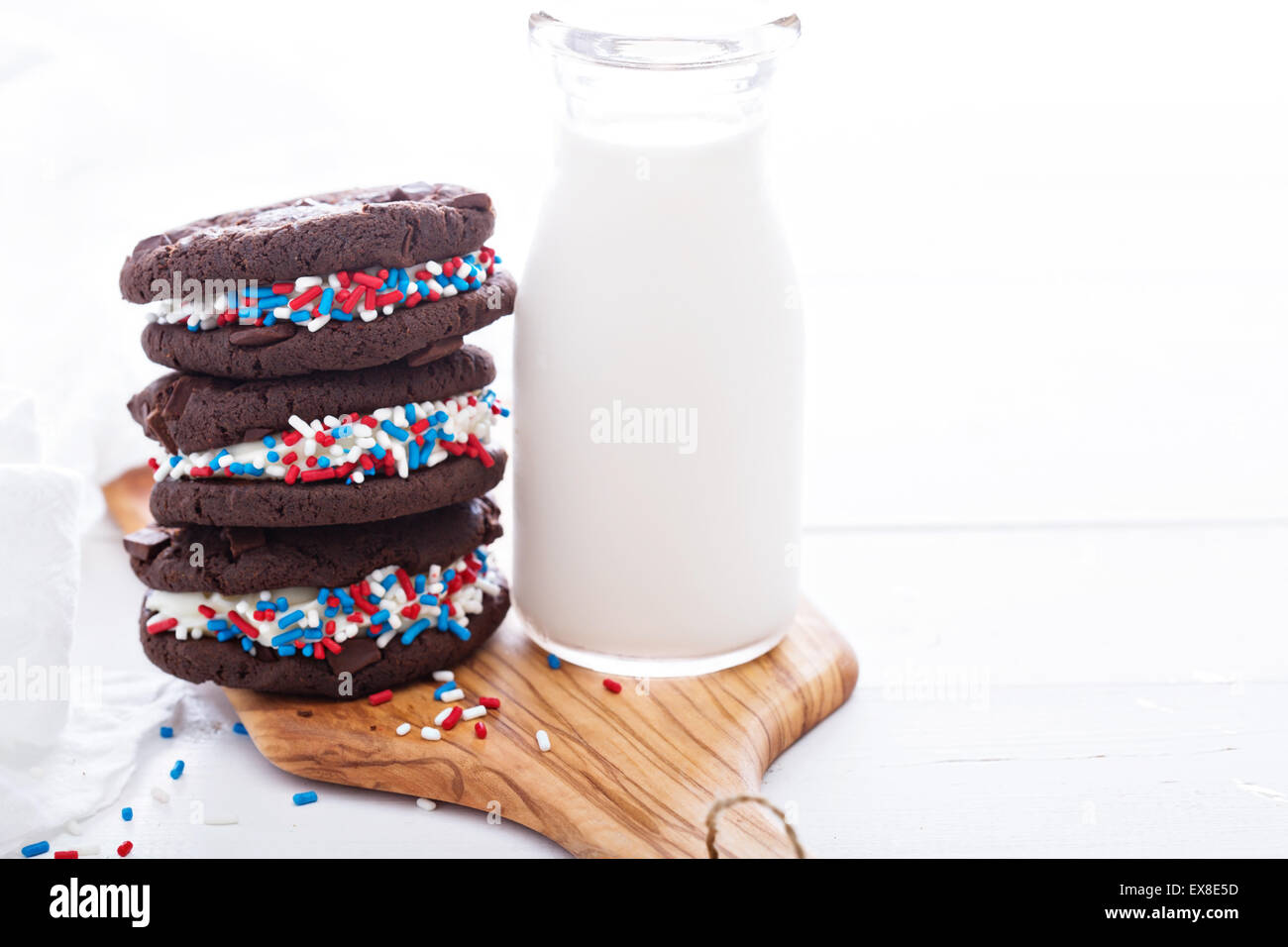 Chocolate sandwich cookies with creamy filling and milk Stock Photo Alamy