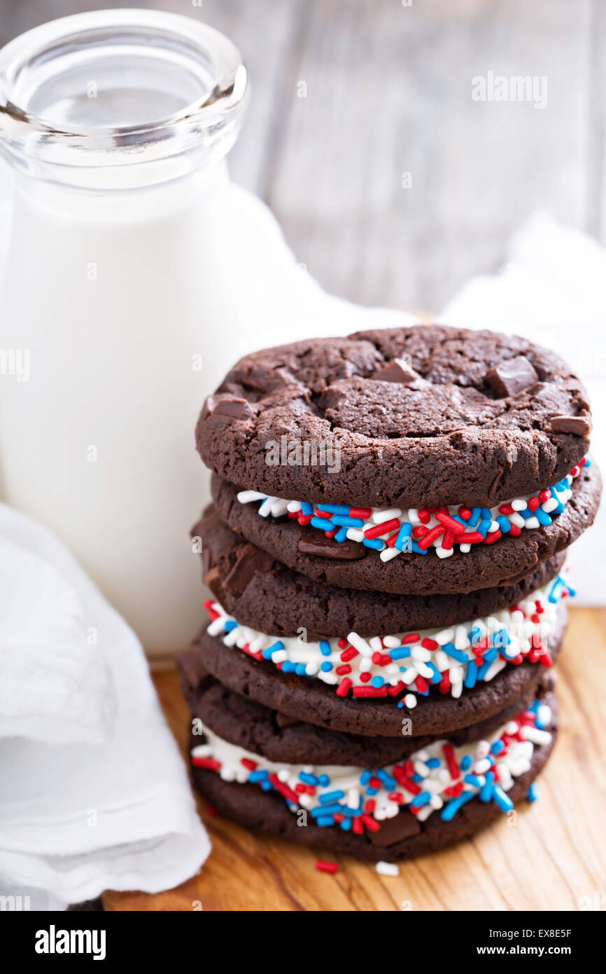 Chocolate sandwich cookies with creamy filling and milk Stock Photo Alamy