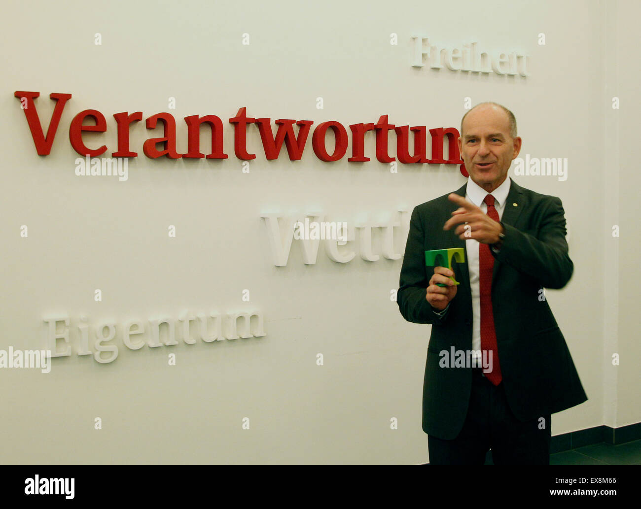 Karl-Erivan Haub, CEO of Tengelmann Group, stands in front of a wall with terms that read 'Verantwortung, Eigentum, Freiheit und Wettbewerb' (lit. responsibility, property, freedom and competition) prior to a press conference in Muelheim an der Ruhr, Germany, 09 July 2015. The corporation currently employs around 72,000 people in Germany and 18 other countries. PHOTO: ROLAND WEIHRAUCH/dpa Stock Photo