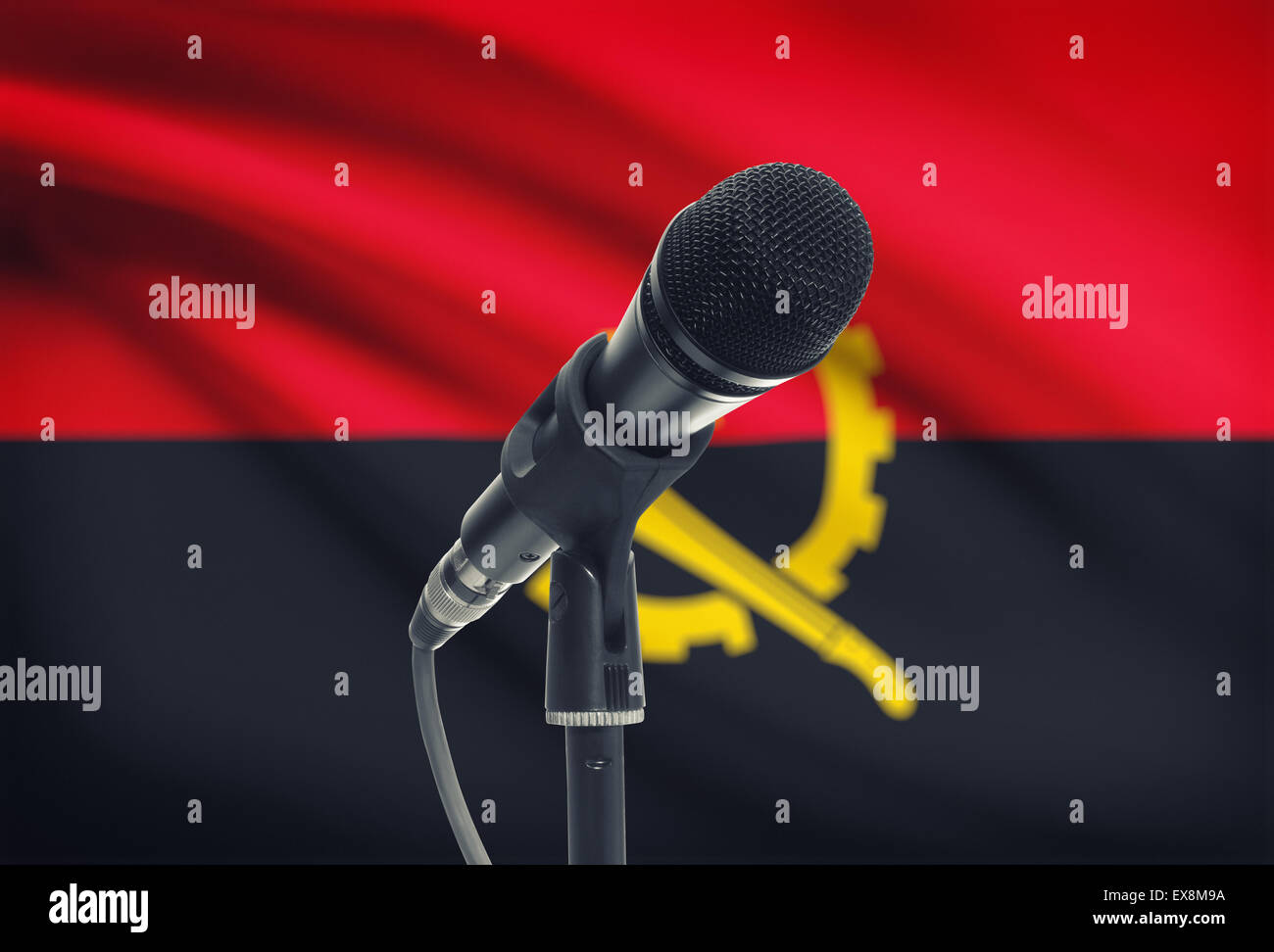 Microphone with national flag on background series - Angola Stock Photo