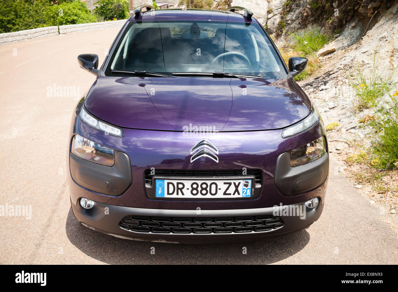 Propriano, France - July 1, 2015: Dark purple new Citroen C4 Cactus on the mountain road of Corsica Stock Photo