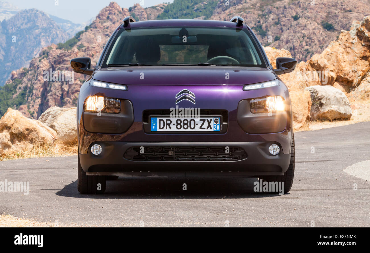 Propriano, France - July 5, 2015: Dark purple new Citroen C4 Cactus on the mountain road of Corsica island Stock Photo