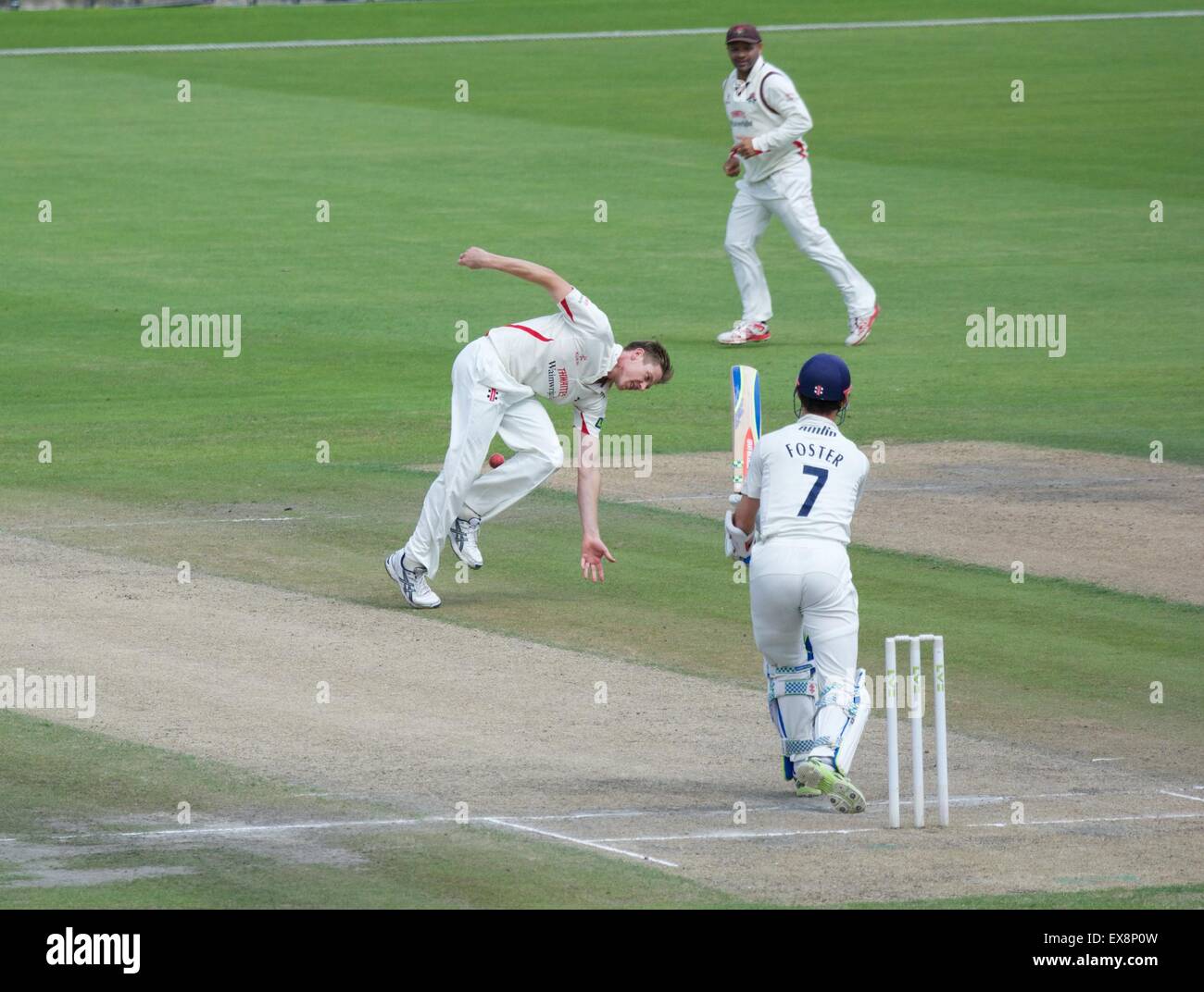 Manchester UK 9th July 2015  James Faulkner tries to field the ball off his own bowling on the fourth day of the County Championship match between Lancashire and Essex at Emirates Old Trafford with Lancashire pressing for an unlikely win in a rain-affected match. Faulkner finished with five wickets. Cricket Lancashire v Essex Manchester, UK Credit:  John Fryer/Alamy Live News Stock Photo