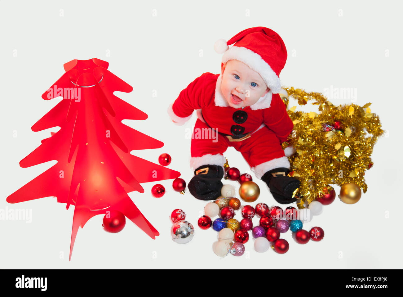 Cute baby in father Christmas outfit Stock Photo