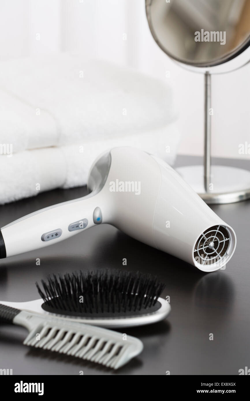 Hair dryer and towels on table Stock Photo Alamy