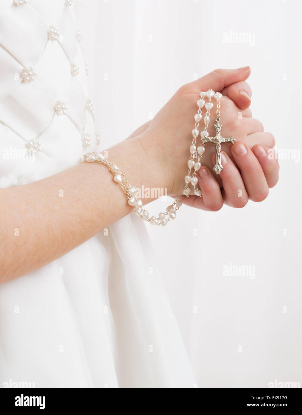 Praying hands holding rosary beads hi-res stock photography and images ...