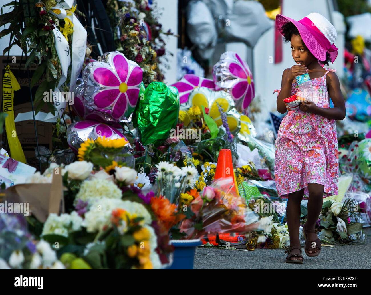 Taylor Jones, 4, from Charleston, looks over the memorial that sprung up in front of Emanuel AME Church in Charleston, SC. Stock Photo