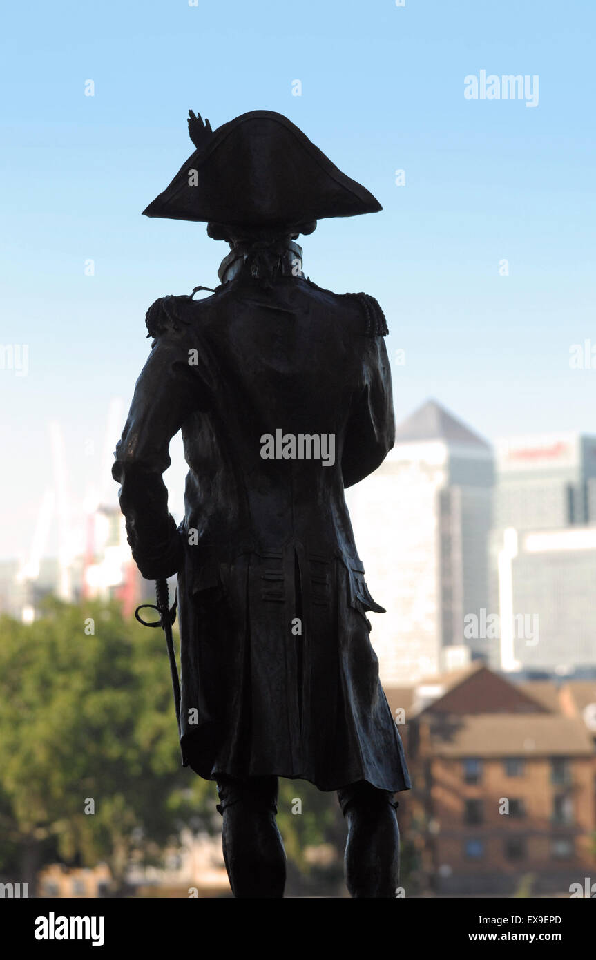Statue of Admiral Lord Nelson in Greenwich, silhouetted against a view across The Thames of Canary Wharf, London Stock Photo
