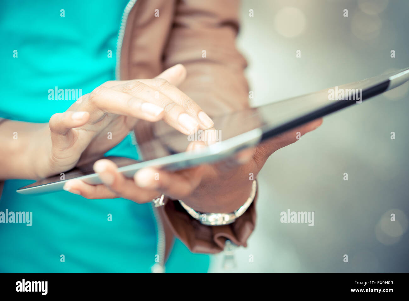 close up of african woman hands using tablet Stock Photo - Alamy