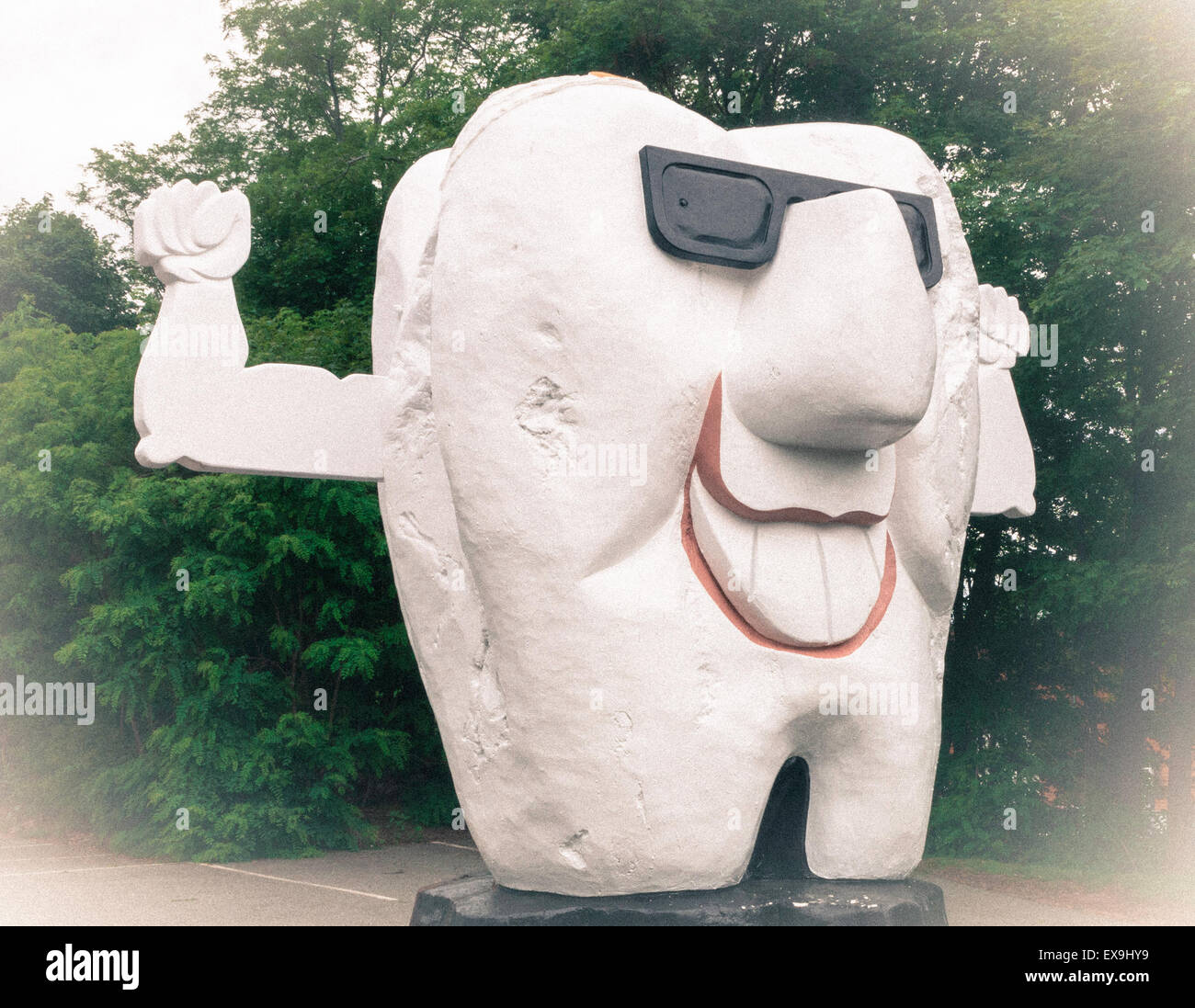 Huge tooth carved wood caricature statue in front of dentist office
