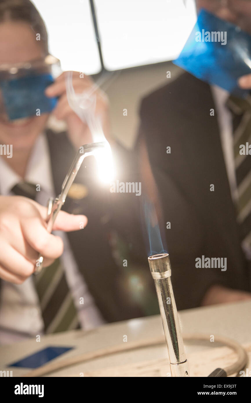 Students in a science lesson using a bunsen burner Stock Photo Alamy