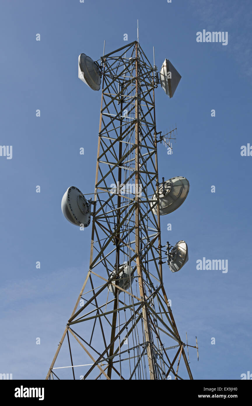 communications antenna tower with parabolic dish and other aerials Stock Photo