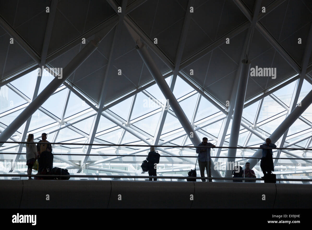 Travelers waiting with luggage (King's Cross, London) Stock Photo