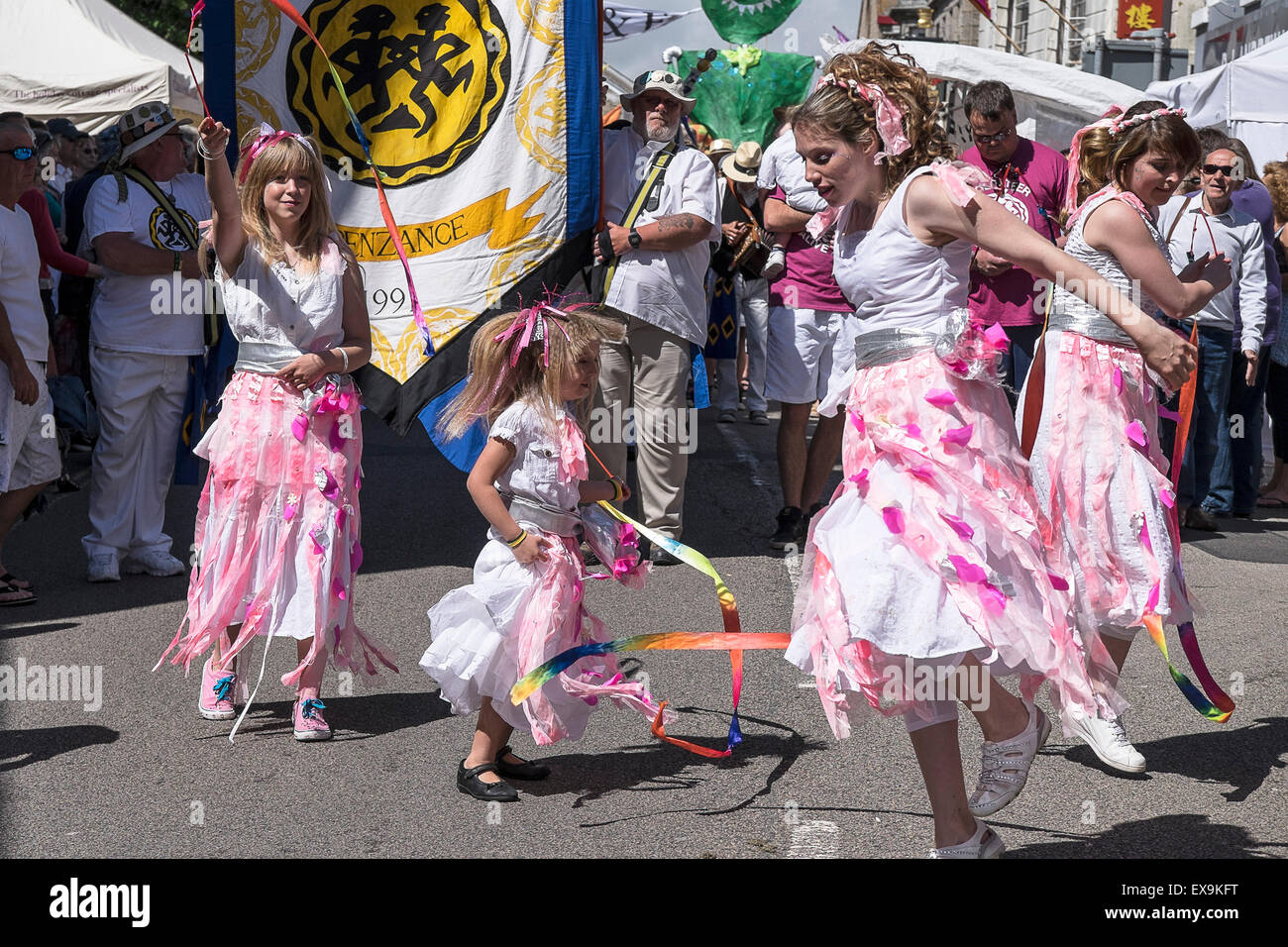 Children and adults participate in colourful parades on Mazey Day, part of the Golowan Festival in Penzance, Cornwall. Stock Photo