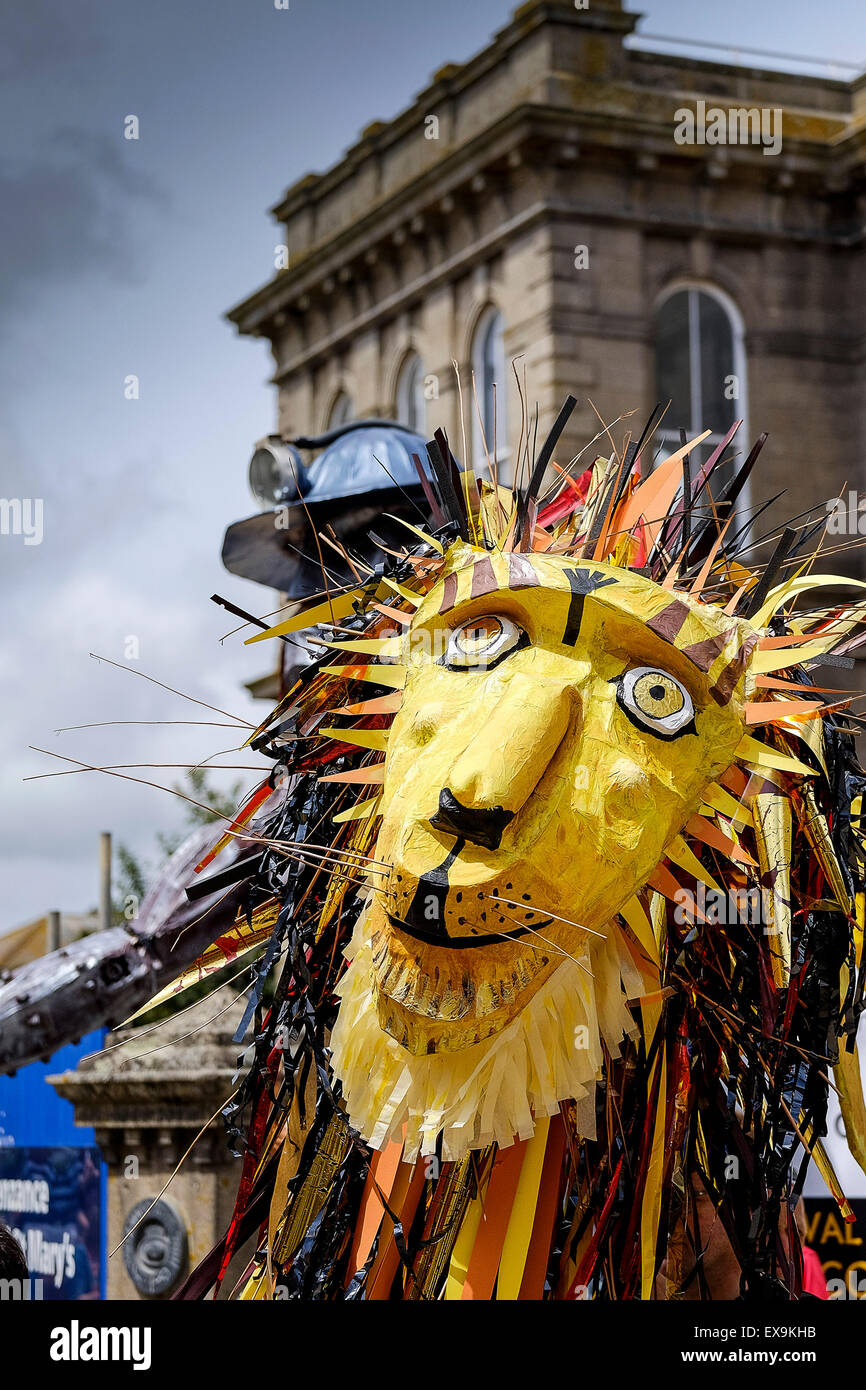 A huge effigy of a lion being carried during on of the colourful parades on Mazey Day, part of the Golowan Festival in Penzance, Stock Photo