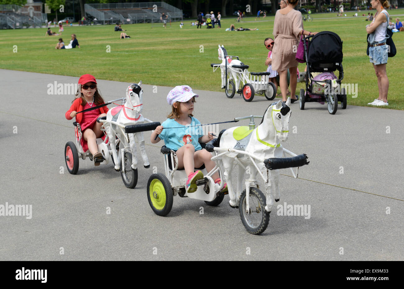 Children riding play playground bikes trikes Annecy France Stock Photo