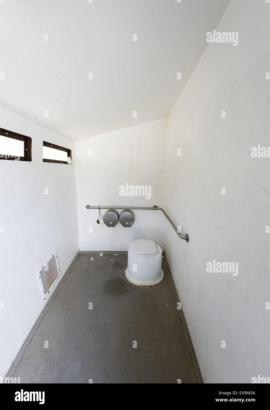 wide angle view of the interior of an outhouse pit toilet Stock Photo