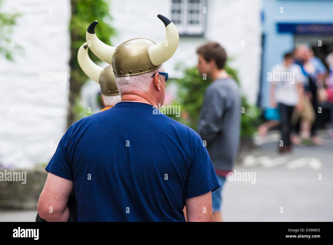 Two holidaymakers wearing plastic viking helmets; Stock Photo