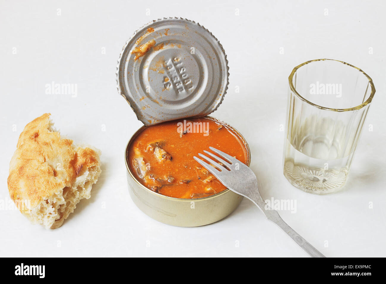 Simple Soviet food. Sprat in tomato sauce and vodka Stock Photo