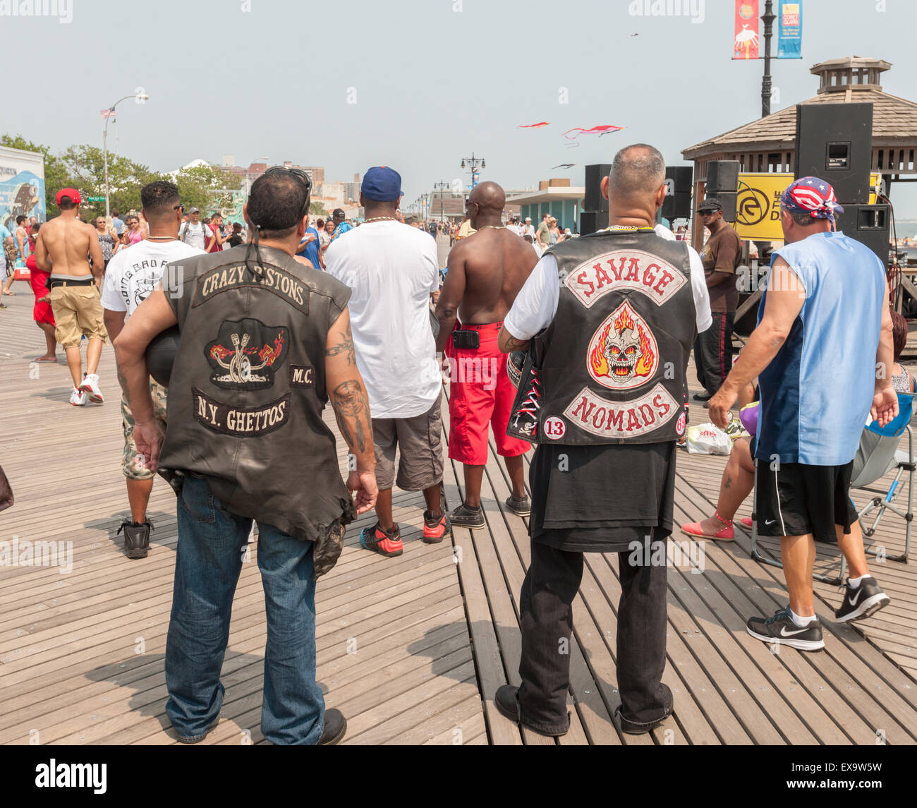 Members of motorcycle clubs in their colors enjoy the boardwalk on a
